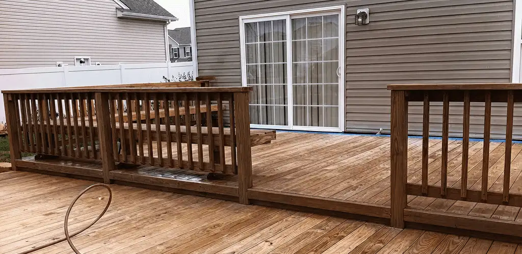 Deck sealing service protecting a backyard wood deck and railings in Long Beach, CA