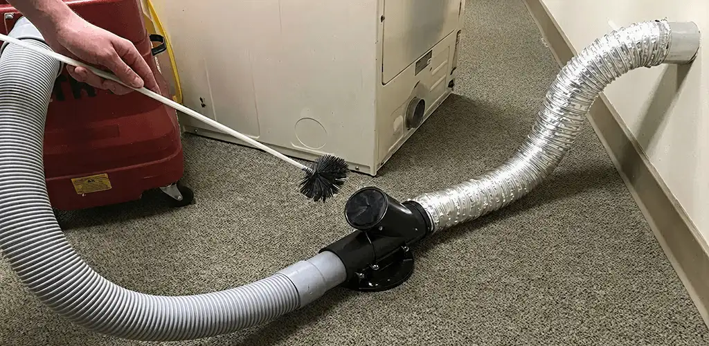 Dryer vent cleaning service removing lint from a dryer duct connection in Long Beach, CA