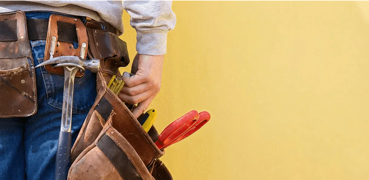 Handyman with tool belt ready for home repairs and maintenance in Long Beach, CA