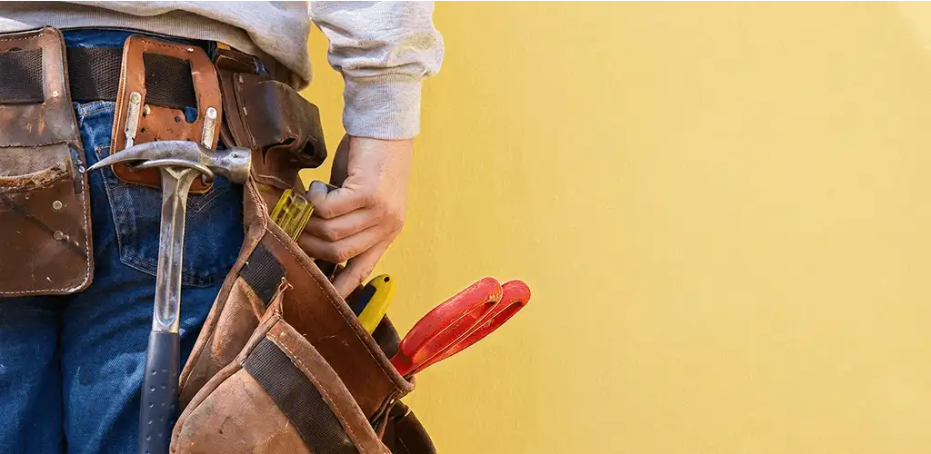 Handyman with tool belt ready for home repairs and maintenance in Long Beach, CA