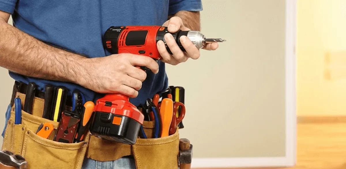 Handyman holding a power drill for home repairs and installations in Long Beach, CA