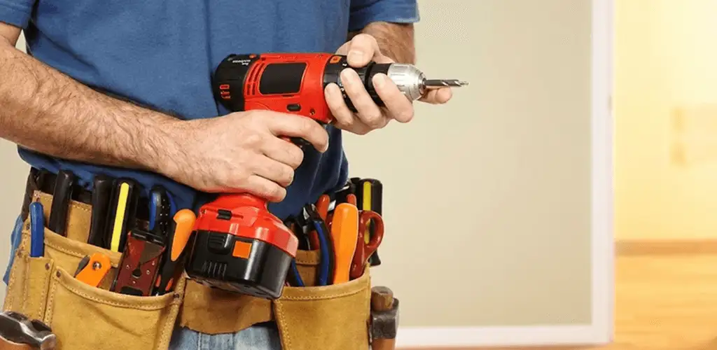 Handyman holding a power drill for home repairs and installations in Long Beach, CA