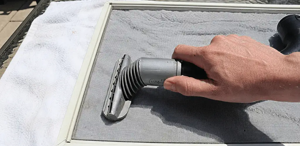 Window screen repair cleaning and fixing a damaged screen mesh in Long Beach, CA